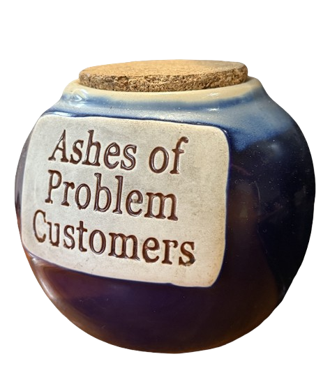 "Ashes of Problem Customers" jar spotted on the counter of <a href='https://www.google.com/maps/place/Mr+Lu's+Burgers+%26+Seafood/@47.6647223,-122.3129914,21z/data=!4m14!1m7!3m6!1s0x5490152b254787f9:0x4c241e05d8758a39!2sScorpio+Cafe!8m2!3d47.6647032!4d-122.3129502!16s%2Fg%2F11y8_24cvn!3m5!1s0x54901461e810742f:0xe59dcfa6e5247d77!8m2!3d47.664598!4d-122.3129536!16s%2Fg%2F1tftqsst?entry=ttu&g_ep=EgoyMDI1MTAyOS4yIKXMDSoASAFQAw%3D%3D' target='_blank' rel='noopener noreferrer'>Mr Lu's Burgers & Seafood</a>, Seattle, WA.